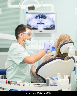 Doctor Dentist with an assistant work in a dental clinic. Stock Photo