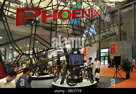 --FILE--People visit the stand of bicycle maker Shanghai Phoenix during the 22nd China International Bicycle and Motor Fair in Shanghai, China, 30 Apr Stock Photo