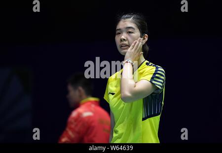 Gao Fangjie of China reacts as she competes against Carolina Marin of Spain in their quarterfinal match of the women's singles during the VICTOR China Stock Photo