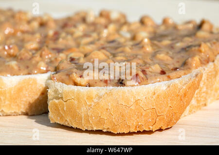 Crunchy Peanut Butter on the kitchen table - close up with selective focus. Stock Photo