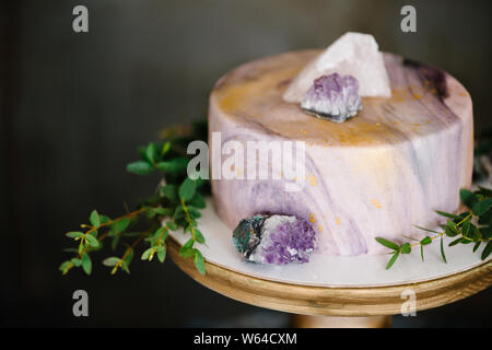 Elegant marble cake with stones, crystals. Wedding or birthday bakery Stock Photo