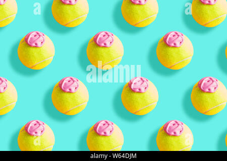 Tennis ball pattern with pink paint - ice cream imitation - on pastel turquoise abstract background Stock Photo