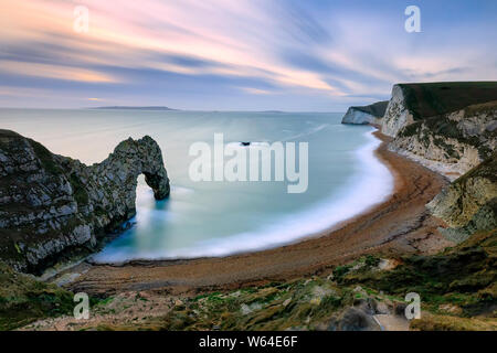 Natural limestone arch on Jurassic coastline of Dorset. Durdle Door. Looking west towards Portland Bill. High angle view. West Lulworth. North Sea. UK Stock Photo