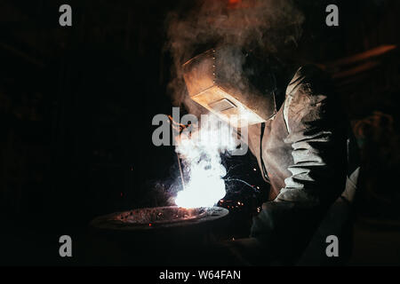 Industrial Worker at the factory welding closeup Stock Photo
