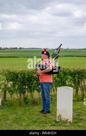 A lone Piper rehearses at the Welsh Memorial Park, Ypres prior to participating in the Last Post Ceremony at the Menin Gate, Ypres. Stock Photo