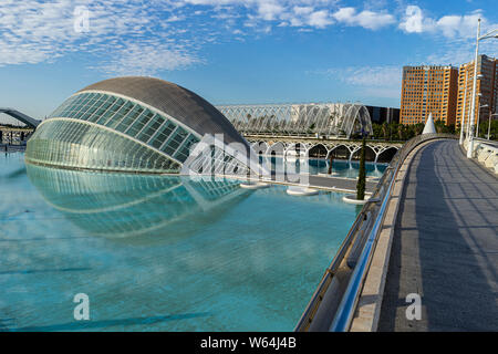 JULY 27, 2019 - VALENCIA, SPAIN. The Hemisferic (1998) planetarium  with the l'Umbracle (2001)  outdoor gallery and garden behind. Part of the CIty of Stock Photo