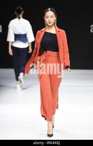 A model displays a new creation at the JD x Something fashion show during the 2018 Beijing Fashion Week in Beijing, China, 17 September 2018. Stock Photo