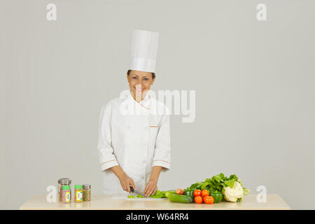 Female chef preparing food and smiling