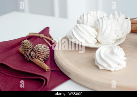 Marshmallow on a plate, white meringue marshmallow background. Flat lay. View from above. Berry sweet homemade marshmallows on a wooden stand. Traditi Stock Photo