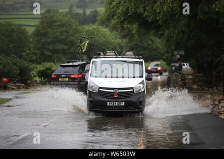 A van being driven through flood water in Yorkshire, after parts of the region had up to 82.2mm of rain in 24 hours on Tuesday. Stock Photo