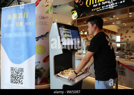 A Chinese Employee Puts His Selects On A Self Service Check Out