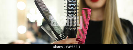 Beautiful Hairdresser Showing Comb and Scissors Stock Photo