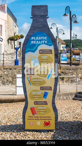 Lyme Regis, Dorset, UK. 31st July, 2019. UK Weather: A giant litter sculpture of takeaway packaging hat has been erected on the picturesque beach at the seaside resort of Lyme Regis. Consisting of an 8 foot high plastic drinks bottle, cutlery measuring 6 foot tall and a chip/burger box measuring 4x4 foot the sculptures promote the efforts of Litter Free Coast and partners in promoting environmentally responsible choices. It is hoped that the temporary installation by architectural designer Jack Raisey will encourage visitors take their litter home. Credit: Celia McMahon/17�Թ����� Live News Credit: Stock Photo