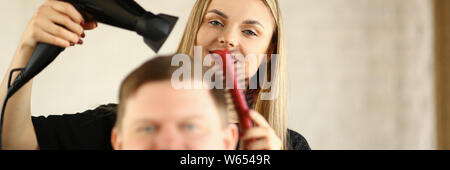 Young Hairdresser Drying Male Hair by Blow Dryer Stock Photo