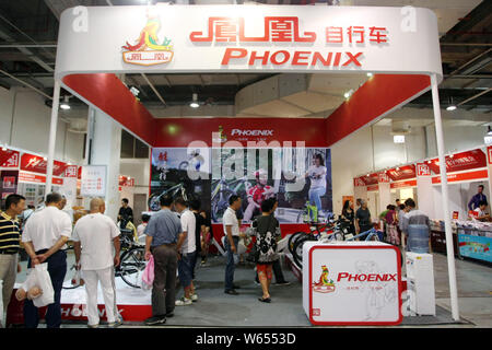 --FILE--People visit the stand of bicycle maker Shanghai Phoenix during an exhibition in Shanghai, China, 26 September 2014.    Bike manufacturers' in Stock Photo