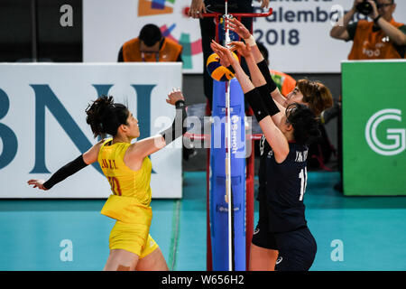 Liu Xiaotong of China, left, spikes against players of South Korea in ...