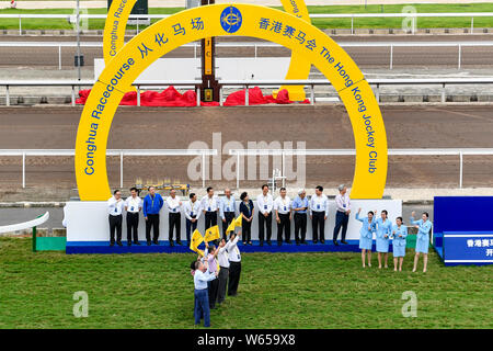 Officials and guests attend the opening ceremony of the Hong Kong Jockey Club Conghua Racecourse in Guangzhou city, south China's Guangdong province, Stock Photo