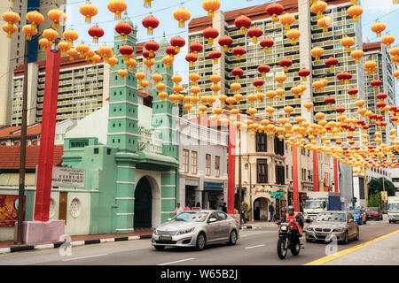 Chinatown, Singapore - February 8, 2019: cars and people on South Bridge Road near Sri Mariamman Temple in Chinatown district with colorful lanterns f Stock Photo