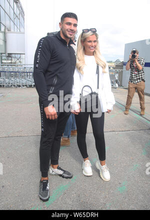 Love Island runners up Tommy Fury and Molly Mae Hague arrive at Stansted Airport in Essex following the final of the reality TV show. Stock Photo