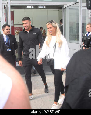 Love Island runners up Tommy Fury and Molly Mae Hague arrive at Stansted Airport in Essex following the final of the reality TV show. Stock Photo