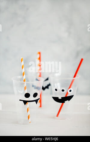 Empty drink glass or cup for the Halloween party.Decorations for children's party with copy space.The concept for Halloween. DIY.Handicraft Stock Photo