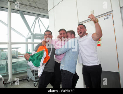 Family and friends greet Love Island winner Greg O'Shea (second left) as the Love Island contestants arrive at Stansted Airport in Essex following the final of the reality TV show. Stock Photo