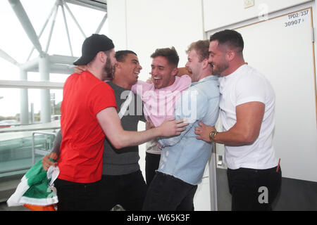 Family and friends greet Love Island winner Greg O'Shea (centre) as the Love Island contestants arrive at Stansted Airport in Essex following the final of the reality TV show. Stock Photo