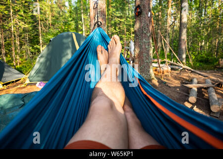 Man resting in a hammock on a summer day during vacation. Stock Photo