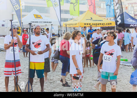 Tel Aviv, Israel, August 12th, 2018: Lots of tourists and locals are swimming at blue Mediterranean sea and spending their vacation at the beach of Stock Photo