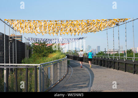 Mature couple running, rear view of a middle aged couple in summer jogging on the High Line in the Chelsea neighborhood of Manhattan, NYC, USA Stock Photo