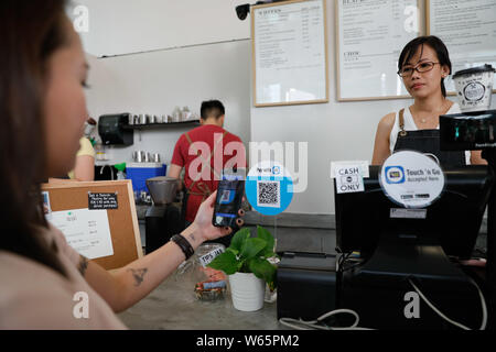 File A Customer Uses Her Smartphone To Scan The Qr Code To Pay Via The Mobile E Wallet Payment Service Touch Go Operated By Tng Digital Sdn Bhd Th Stock Photo Alamy