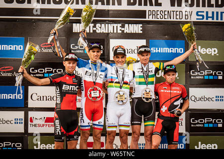 AUGUST 3, 2014 - MONT SAINTE ANNE, CANADA. UCI MTB XC World Cup Podium: 1. Nino Schurter, 2. Julien Absalon, 3. Dan McConnell, 4. Lukas Fluckiger, 5. Stock Photo