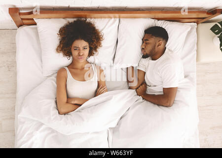 Young couple in bed having problems and crisis Stock Photo