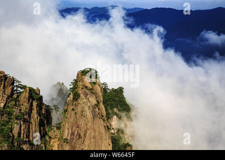 --FILE--Landscape of mountain tips rising above enchanting clouds at the Yellow Mountain scenic spot in Huangshan city, east China's Anhui province, 1 Stock Photo