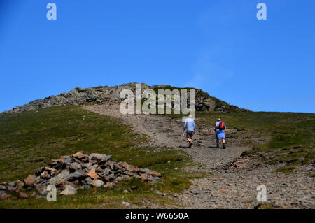Two Men Walking on the Path to the Summit of the Wainwright Hopegill Head from the Lake District National Park, Cumbria, England, UK. Stock Photo
