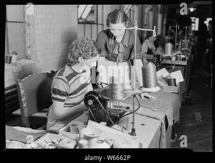 High Point, North Carolina - Upholstering. Tomlinson Chair Manufacturing Co. Seamstress - upholstering - sewing and cutting of cloth (all women) Stock Photo