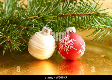 Red and white Christmas baubles in fresh conifer tree branches Stock Photo