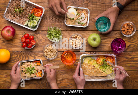 Foil boxes, fruits, nuts and vegetables on wooden table Stock Photo