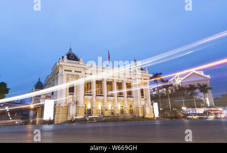 Hanoi, Vietnam - May 2019: evening view of city opera house with traffic lights, long exposure Stock Photo