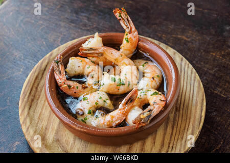 Garlic prawns, traditional Spanish tapas on and ceramic bowl. Stock Photo