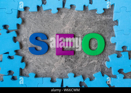 SEO, Search Engine Optimization ranking concept.Alphabets abbreviation SEO in a middle of jigsaw puzzle frame Stock Photo