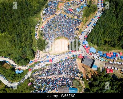 An aerial view of visitors and local people of Miao and Dong ethnical minorities watching a bullfight to mark Liu Yue Liu, or the sixth day of the six Stock Photo