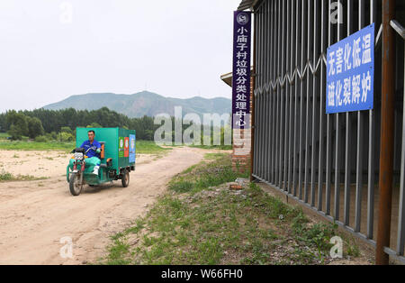 (190731) -- CHIFENG, July 31, 2019 (Xinhua) -- Villager Zhang Yukui transports garbage bins in Xiaomiaozi Village of Damiao Township in Chifeng City, north China's Inner Mongolia Autonomous Region, July 16, 2019. (Xinhua/Liu Lei) Stock Photo