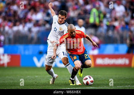 Roman Zobnin of Russia, left, challenges David Silva of Spain in their Round of 16 match during the 2018 FIFA World Cup in Moscow, Russia, 1 July 2018 Stock Photo