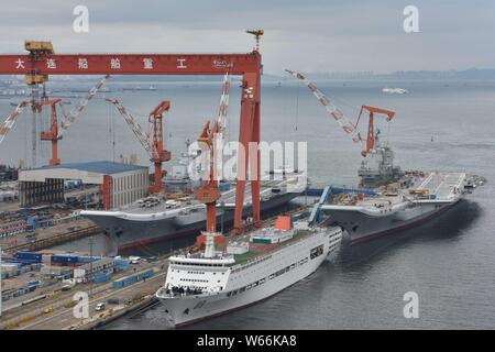 China's first domestically built aircraft carrier, right, the Type 001A, and China's first aircraft carrier, the Liaoning, are pictured at the shipyar Stock Photo