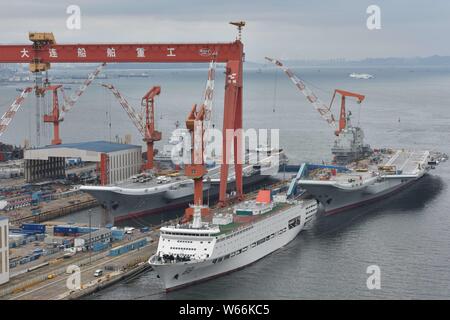 China's first domestically built aircraft carrier, right, the Type 001A, and China's first aircraft carrier, the Liaoning, are pictured at the shipyar Stock Photo