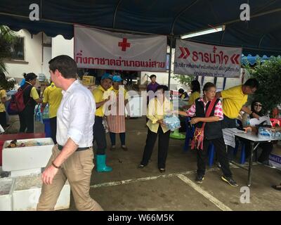 Volunteers prepare food and distribute supplies at a temporary media center in Chiang Rai province, Thailand, 10 July 2018.   All 12 boys and their fo Stock Photo