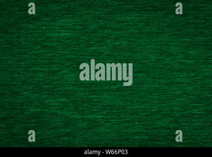 Abstract texture of a rough dark green paper background and copy space for text. Macro fiber paper. Stock Photo