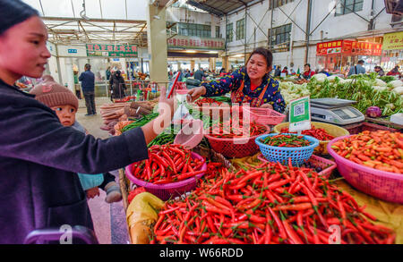 --FILE--A customer uses her smartphone to scan the QR code of WeChat Payment of the messaging app Weixin, or WeChat, of Tencent to pay her purchase at Stock Photo