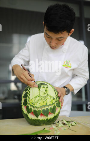 Chinese teacher Jiang Zhongmin shows watermelon carvings of Portuguese football player Cristiano Ronaldo in Shenyang city, northeast China's Liaoning Stock Photo
